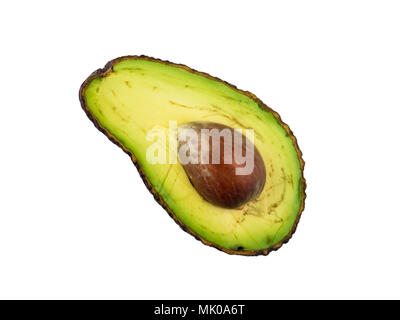 Ripe creamy avocado exotic fruit with seed and imperfections half cut top view flat lay isolated on white Stock Photo