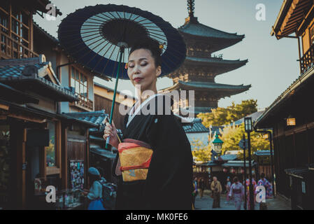 Japanese woman wearing traditional dress at Yasaka Pagoda, Kyoto