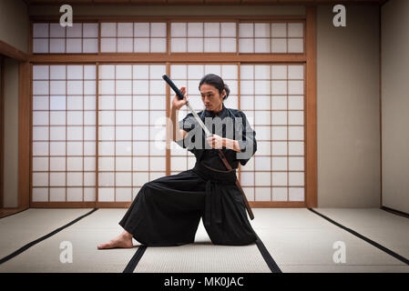 Japanese martial arts athlete training kendo in a dojo - Samaurai practicing in a gym Stock Photo