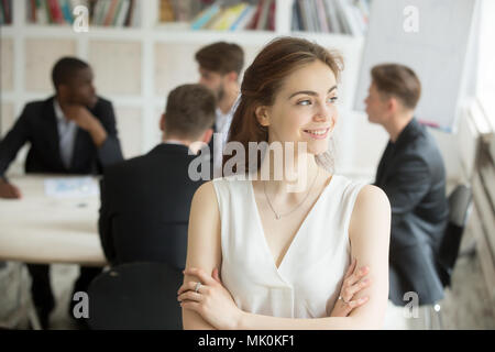 Business woman looking to side at corporate meeting Stock Photo