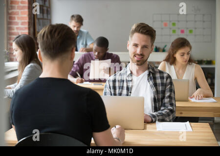 Male student happily looking at camera after exam Stock Photo