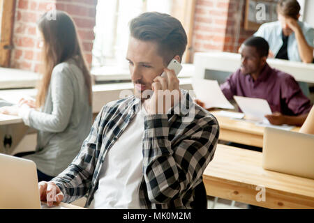Male manager consulting client over cellphone Stock Photo