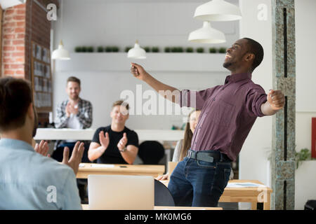 Exited african american dancing victory dance in office Stock Photo