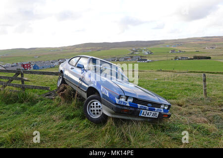 Classic Ford Capri involved in a an accident were it has gone of the road and into a fence Stock Photo