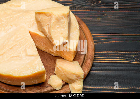 Whole round Head and pieces of parmesan or parmigiano Stock Photo