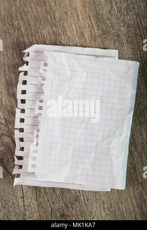 Torn sheets in notebook on table Stock Photo