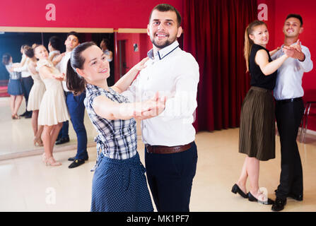 Young people dancing together slow ballroom dances in pairs Stock Photo