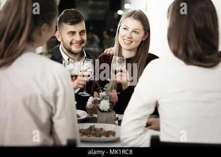 Friends are having dinner in the restaurante indoor. Stock Photo