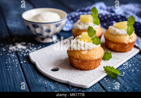 Coconut and pineapple muffins with yoghurt topping Stock Photo