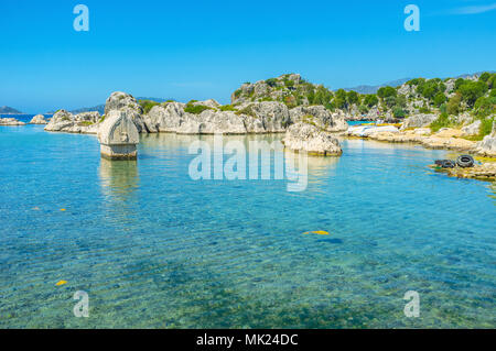 The ancient Lycian tomb in water at the coastline of Kalekoy resort, famous for preserved remains of Simena settlement, Kekova bay, Turkey. Stock Photo