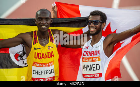 GOLD COAST, AUSTRALIA - APRIL 8: Joshua Kiprui Cheptegei of Uganda and Mohammed Ahmed of Canada celebrate after competing in the Men's 5000m final at  Stock Photo