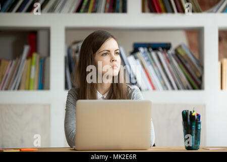 Concentrated businesswoman thinking about problem solution Stock Photo