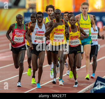 GOLD COAST, AUSTRALIA - APRIL 8: Joshua Kiprui Cheptegei of Uganda and Mohammed Ahmed of Canada competing in the Men's 5000m final at the Gold Coast 2 Stock Photo