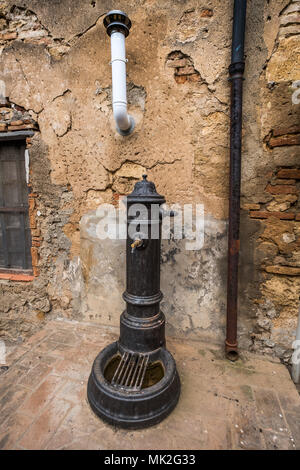 Bibbona, Leghorn, Italy - April 2018 the medieval village of Bibbona in Tuscany, source of water in the historic center Stock Photo