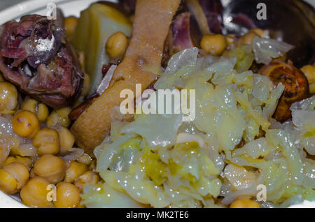 A plate of traditional dish from Madrid, Spain called cocido madrileno (Madrid stew), made with chickpeas, potatoes, cabage and various types of meat Stock Photo
