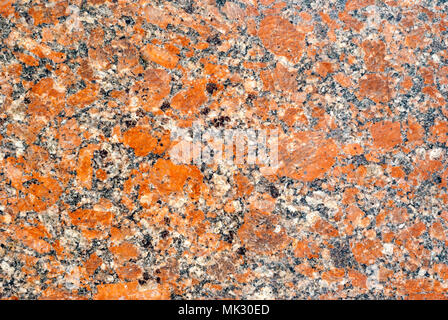 background, texture - variegated surface of polished granite slab with orange splashes Stock Photo