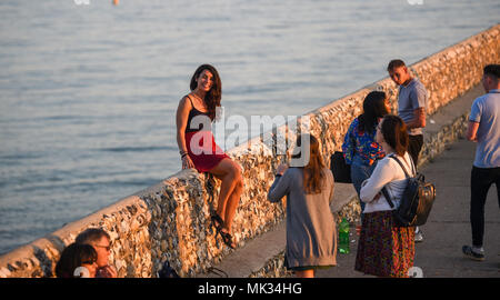 Brighton UK 6th May 2018  - Time for one last photo as visitors make the most of the last of the sun on Brighton beach after a hot day on the south coast with the good weather set to continue over the bank holiday throughout Britain Credit: Simon Dack/Ģ����ý Live News Stock Photo