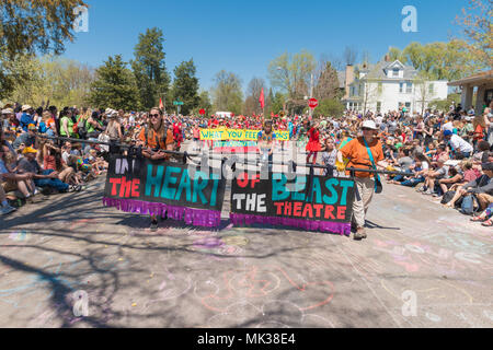 MINNEAPOLIS - May 6, 2018: Individuals hold a banner leading Minneapolis’ yearly May Day parade. Organized by In the Heart of the Beast Puppet and Mask Theatre, the parade, ceremony, and festival is in its 44th year. Credit: Nicholas Neufeld/Alamy Live News Stock Photo