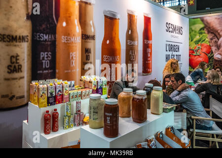 Stand of the Catalan brand Sesmans Sauces. BioCultura, the Organic Products Fair and Responsible Consumption celebrates its 25th anniversary. It will bring together over 700 exhibitors dedicated to the sectors of food bio, organic cosmetics, sustainable fashion, home safe, responsible tourism, crafts and NGOs. Parallel to the exhibition more than 400 activities will be held and is expected to exceed 72,000 visitors. It will be held from 3 to 6 May at the Palau Sant Jordi in Barcelona. Stock Photo