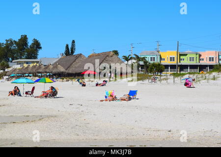 Bradenton Beach on Anna Maria Island in Florida.  Colorful small town with thatched roof restaurant on the beach with people. Stock Photo