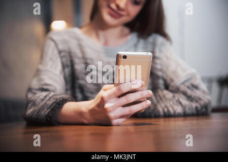 an attractive girl with long black hair ponders a new project during a coffee break sitting at a table in a coffee shop Stock Photo
