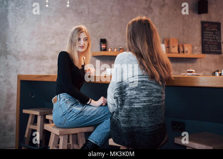 Toned picture of best friends having date in cafe or restaurant. Beautiful girls talking or communicating while drinking coffee Stock Photo