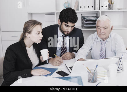 Managers are writing financial reports in the office. Stock Photo