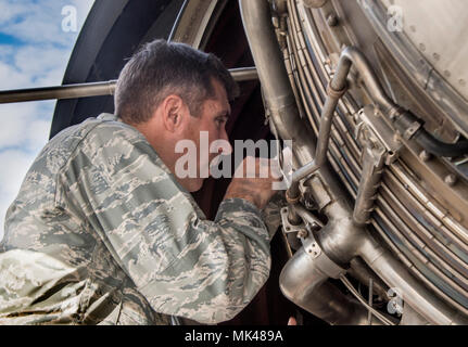 U.S. Air Force Col. John Klein, the commanding officer of the 60th Air Mobility Wing works on a KC-10 Extender aircraft engine, Nov. 3, 2017, Travis Air Force Base, Calif., as part of the Leadership Rounds program with Airmen from the 660th Aircraft Maintenance Squadron. The 660th AMXS is responsible for the safety and reliability of the fleet, thus strengthening American air power across the globe. (U.S. Air Force photo by Heide Couch) Stock Photo