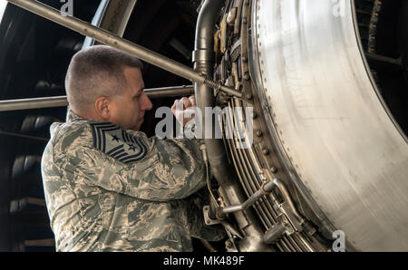 U.S. Air Force Chief Master Sgt. Steve Nichols, command chief of the 60th Air Mobility Wing works on a KC-10 Extender aircraft engine, Nov. 3, 2017, Travis Air Force Base, Calif., as part of the Leadership Rounds program with Airmen from the 660th Aircraft Maintenance Squadron. The 660th AMXS is responsible for the safety and reliability of the fleet, thus strengthening American air power across the globe. (U.S. Air Force photo by Heide Couch) Stock Photo