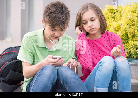 Teen boy and girl with headphones Stock Photo