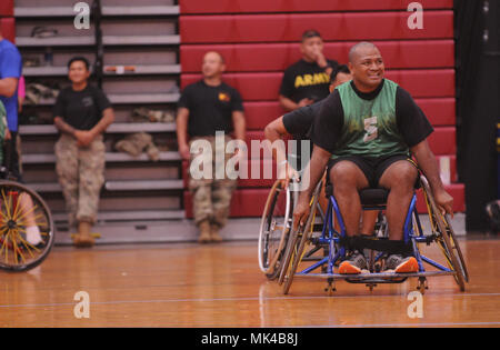 U.S. Army active duty and veteran athletes compete in wheelchair basketball for the 2017 Pacific Regional Warrior Game Trials Army Trials on Schofield Barracks, Hawaii, November 8, 2017. Approximately 80 wounded, ill or injured soldiers and veterans are in Hawaii to train and compete in a series of competitive athletic events including archery, cycling, shooting, sitting volleyball, swimming, track and field and wheelchair basketball. These competitions take place during November, which also coincides with Warrior Care Month. During Warrior Care Month we focus on activities that allow us to co Stock Photo