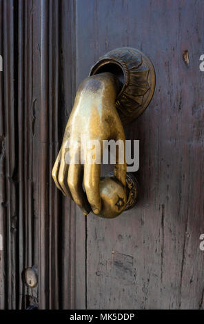 In San Miguel de Allende, an ornate brass hand door knocker Stock Photo
