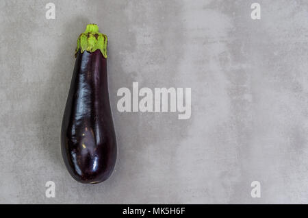 Great concept of healthy eating, eggplant on gray background, polished concrete. Stock Photo