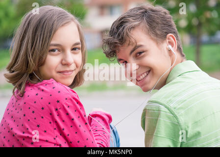 Teen boy and girl with headphones Stock Photo