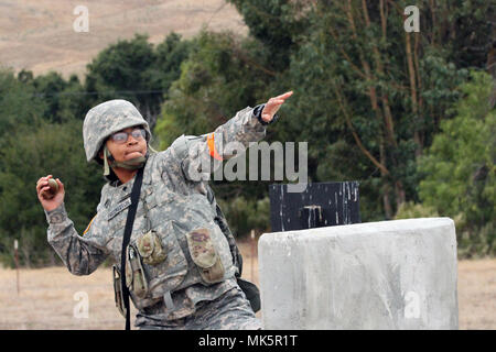 Spc. Emefa Freckleton prepares to throw a grenade simulator Nov. 8 during the California Army National Guard's 2017-18 Best Warrior Competition at Camp San Luis Obispo, California. This was one of the last tests after four competitive days to find California’s Best of the Best. (Army National Guard photo by Staff Sgt. Eddie Siguenza) Stock Photo