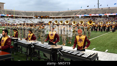 The 36th Infantry Division Marching Band participated in the halftime show at the Texas State University football game against Georgia State University in honor of Veterans Day, Nov. 11, 2017 in San Marcos, Texas. The dual marching bands performed a medley comprised of each military branch's service song with the Division's Bandmaster, Chief Warrant Officer 4 Jeffery Lightsey, conducting. Veterans Day began to show respect for past, present and fallen service members nearly 100 years ago, after the signing of the armistice following World War One. The 36th Inf. Div. has soldiers deployed aroun Stock Photo