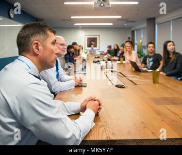 60th Air Mobility Wing is a unit of the United States Air Force responsible for global airlift operations. The archival image documents unit leadership engaging with corporate employees during a professional development workshop at a social media company headquarters in San Francisco on November 9, 2017. Stock Photo