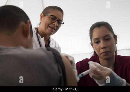 https://l450v.alamy.com/450v/mk621j/san-juan-puerto-rico-rubi-delmar-a-nursing-student-at-universidad-metropolitana-administers-a-vaccine-to-a-patient-under-the-watchful-eye-of-her-professor-reina-rivera-at-an-annual-health-clinic-in-bayamon-puerto-rico-nov-14-2017-local-medical-students-and-professionals-volunteered-at-the-event-where-federal-emergency-management-agency-specialists-were-on-hand-to-pass-out-food-and-water-as-well-as-to-help-with-disaster-survivor-assistance-claims-us-army-photo-by-spc-samuel-d-keenan-mk621j.jpg