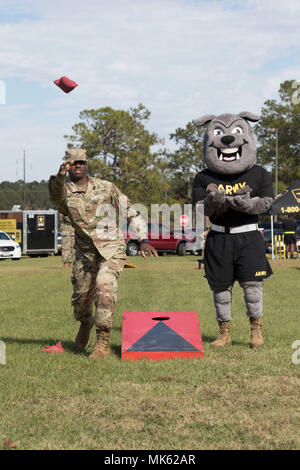 Sgt. Rocky, 3rd Infantry Division's mascot, plays a bean bag toss game with Pfc. Trent Kelly, a Dog Face Soldier assigned to 24th Ordnance Company, 87th Combat Sustainment Support Battalion, 3rd Infantry Division Sustainment Brigade, November 14, 2017 during a Family Fun Day at Fort Stewart, Ga. This event took place during Marne Week, a celebration for Soldiers to participate in recreational activities while honoring the division's service to the nation. This month marks the centennial anniversary of the Marne Division. (U.S. Army photo by Sgt. Caitlyn Smoyer/Released) Stock Photo