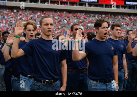 Military recruits recite the oath of enlistment given by Marine Lt. Gen. Joseph Osterman, deputy commander of U.S. Special Operations Command, during the Tampa Bay Buccaneers Salute to Service game in Tampa, Fla., Nov. 15, 2017. The game provided the NFL and fans a forum to honor service members, veterans and their families. (Photo by U.S. Air Force Master Sgt. Barry Loo) Stock Photo