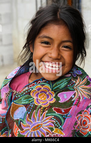 Zinacantan, Mexico - November 8, 2013: A young indigenous Tzotzil Maya girl smiling outside her home in a rural village near San Cristobal de la Casas Stock Photo