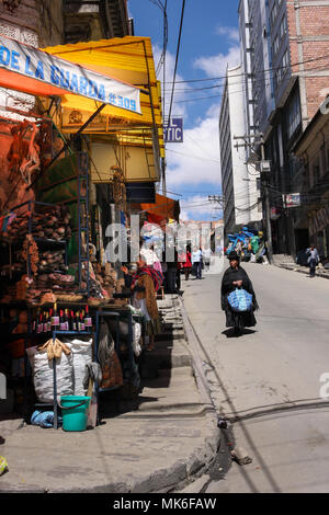 LA PAZ, BOLIVIA - SEPTEMBER 27, 2011: A witch doctor dressed in traditional black wanders the streets of the Witches Market in Bolivia's capital where Stock Photo