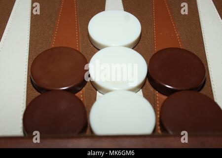 a set of backgammon pieces set up in the middle of a game Stock Photo
