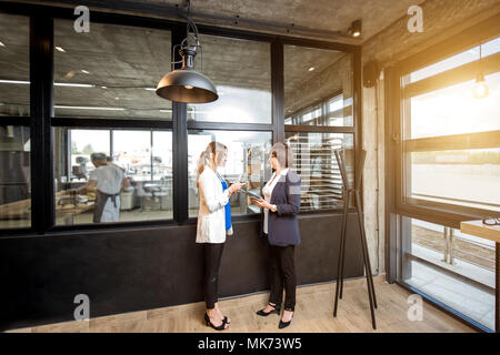 Bakery office with business women talking together Stock Photo