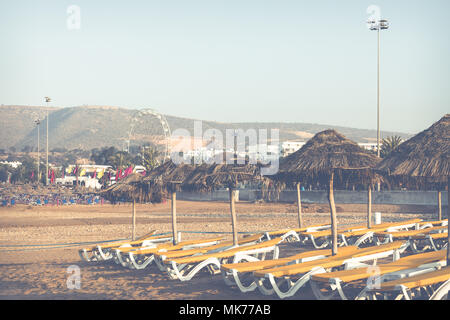 Beach loungers and umbrellas on the sea. Main beach in Agadir city located on the shore of the Atlantic Ocean.Morocco. Stock Photo