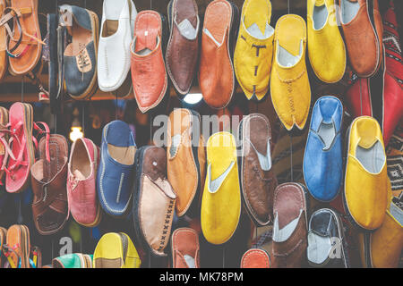 Moroccan leather goods bags and slippers at outdoor market in Marrakesh, Morocco. Stock Photo