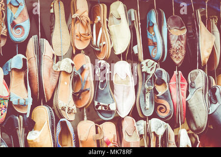 Moroccan leather goods bags and slippers at outdoor market in Marrakesh, Morocco. Stock Photo