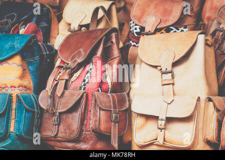 Moroccan leather goods bags and slippers at outdoor market in Marrakesh, Morocco. Stock Photo