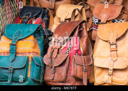 Moroccan leather goods bags and slippers at outdoor market in Marrakesh, Morocco. Stock Photo