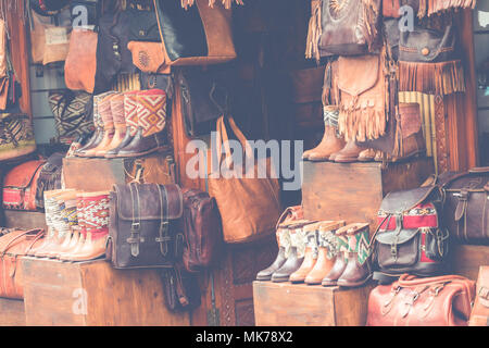 Moroccan leather goods bags and slippers at outdoor market in Marrakesh, Morocco. Stock Photo